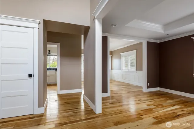 a view of empty room with window and ceiling fan