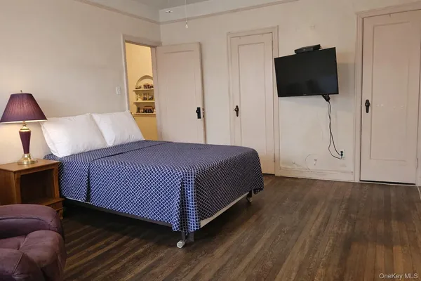 a room with a book shelf and a wooden floor