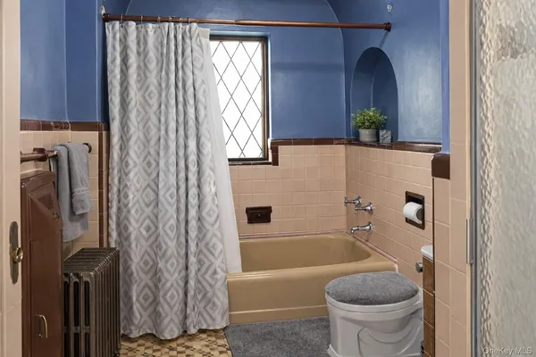 a white toilet sitting next to a small sink