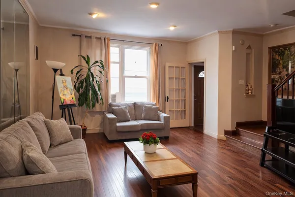 a dining room with wooden floor and furniture