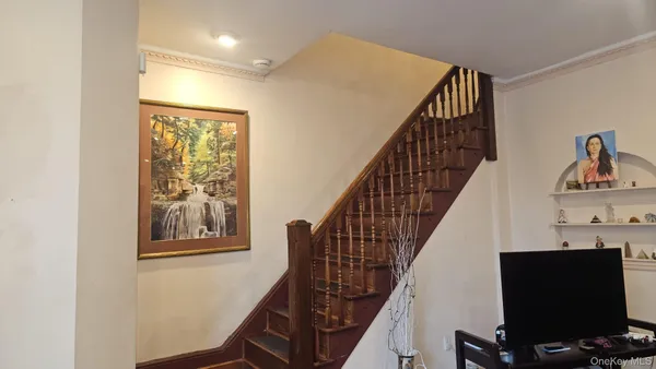 a view of staircase with wooden floor and white walls