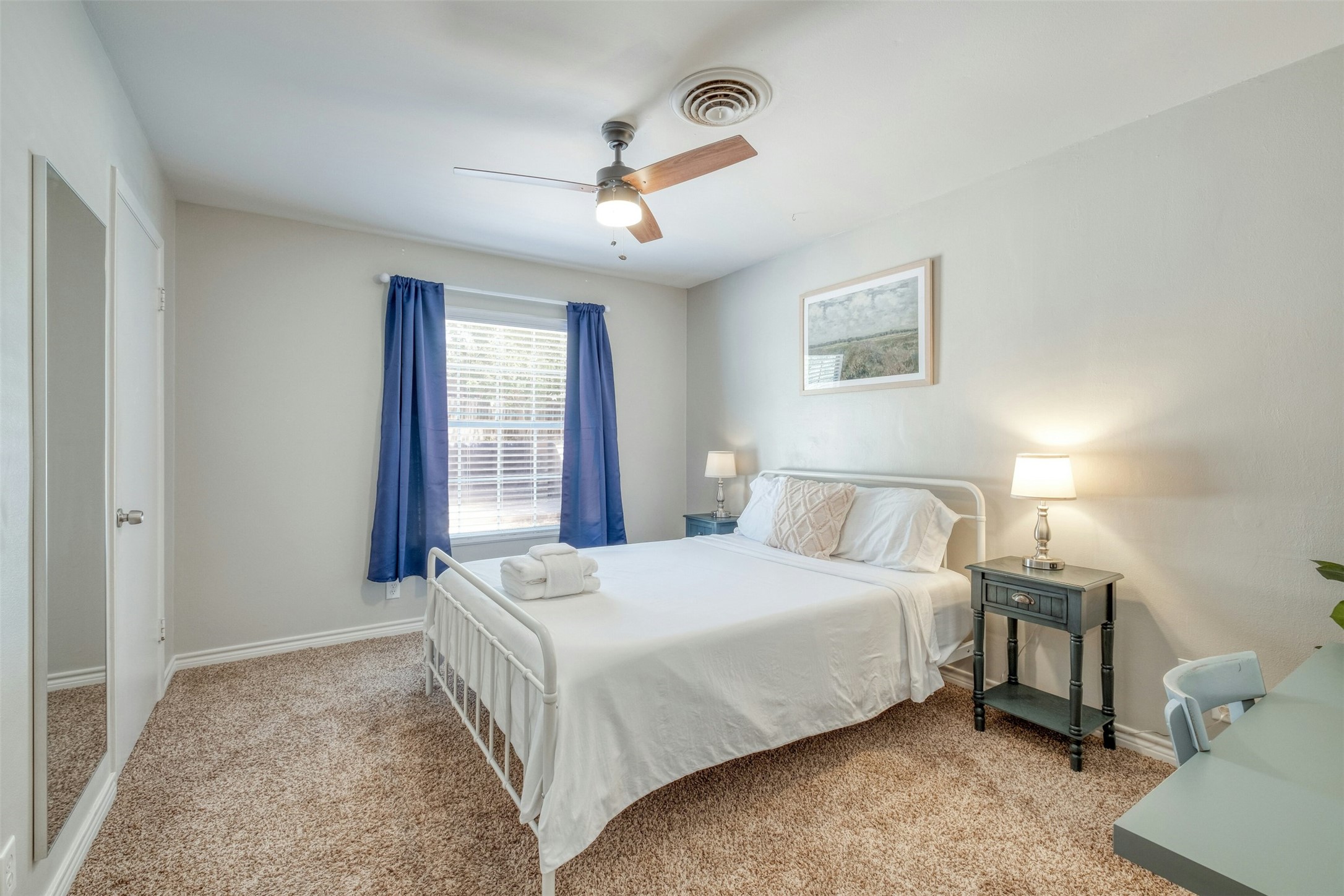 1208 Country Club Road Georgetown, TX 78628 - Photo 20 of 25 a bedroom with a large bed and a chandelier