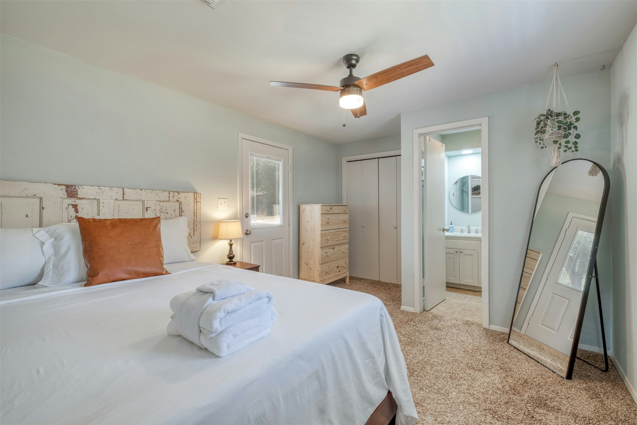 1208 Country Club Road Georgetown, TX 78628 - Photo 22 of 25 a bedroom with a large bed and a chandelier