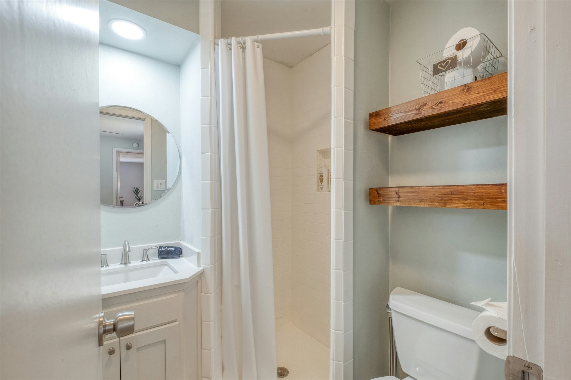 1208 Country Club Road Georgetown, TX 78628 - Photo 23 of 25 a bathroom with a toilet a sink and mirror