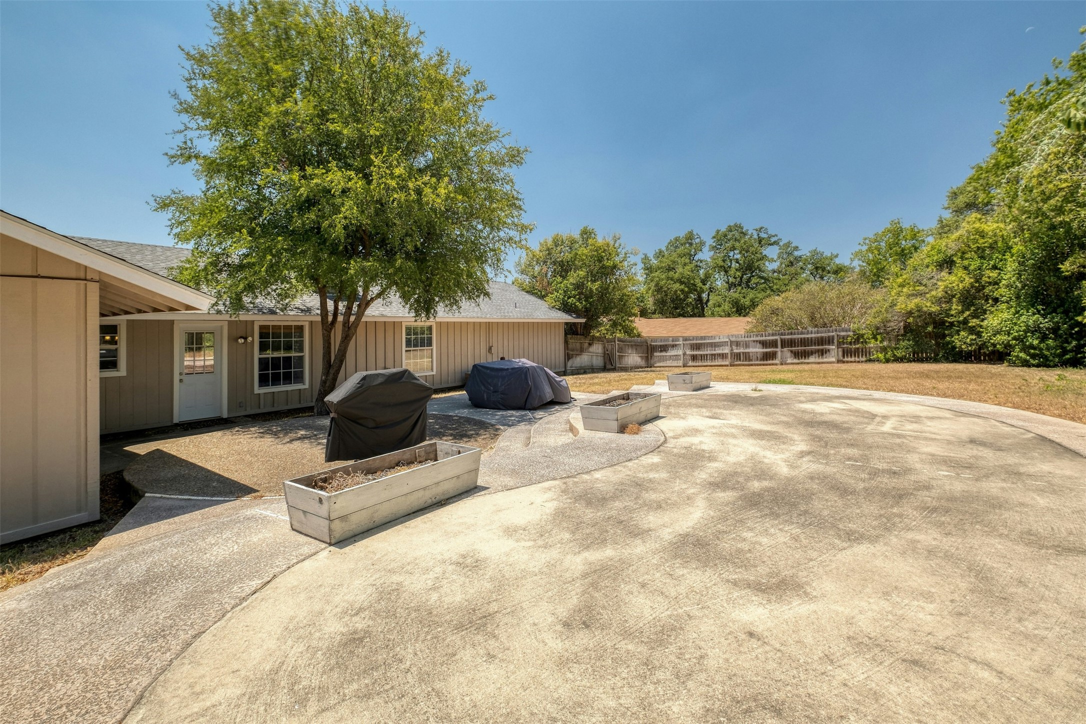 1208 Country Club Road Georgetown, TX 78628 - Photo 25 of 25 a backyard of a house with table and chairs under an umbrella