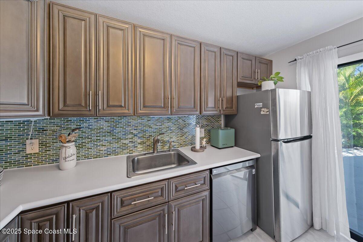 2012 Dan Court Palm Bay, FL 32905 - Photo 12 of 22 a kitchen with stainless steel appliances granite countertop a refrigerator a sink a stove and white cabinets