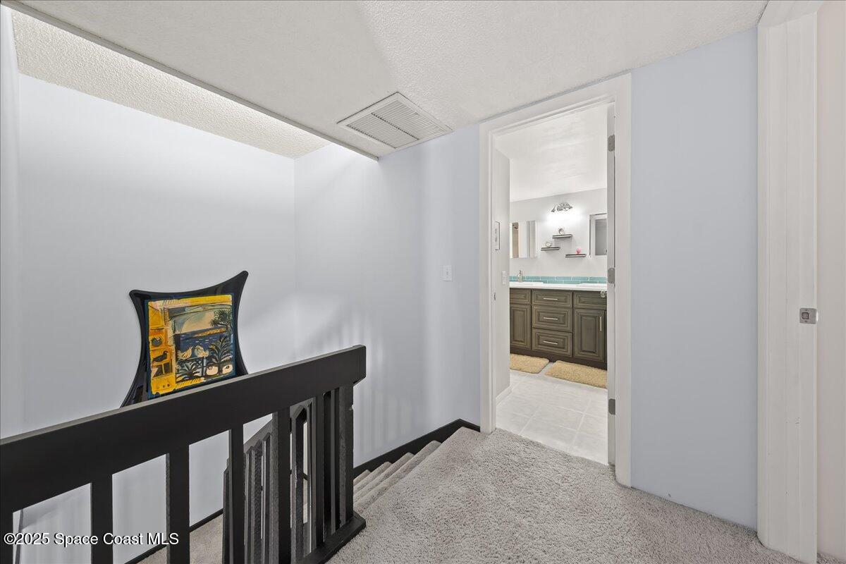 2012 Dan Court Palm Bay, FL 32905 - Photo 15 of 22 a view of a hallway to a livingroom with wooden floor and furniture