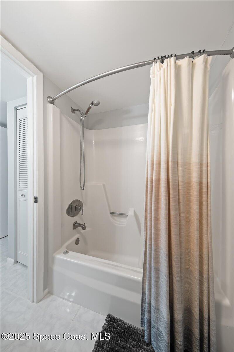 2012 Dan Court Palm Bay, FL 32905 - Photo 20 of 22 a bathroom with a shower curtain and a bathtub