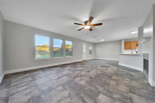 a view of a kitchen with a sink and a chandelier fan