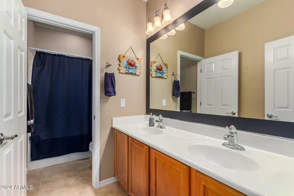 a bathroom with double vanity sink and a mirror