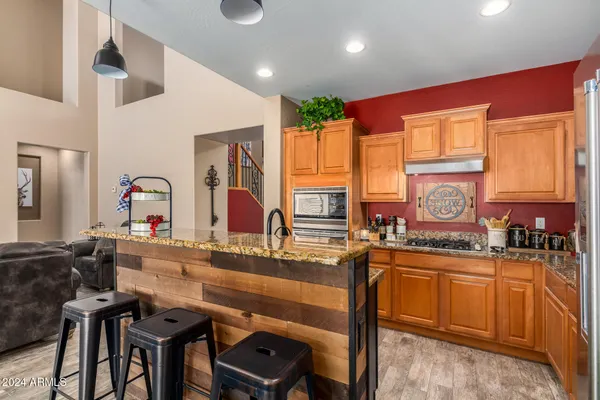 a kitchen with a sink stove and chairs