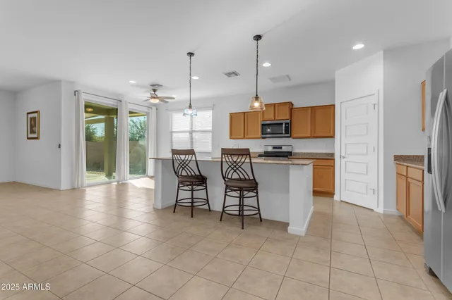a living room with furniture and a ceiling fan