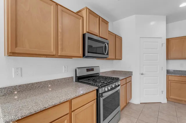 a en suite bathroom with a double vanity sink a mirror and a shower