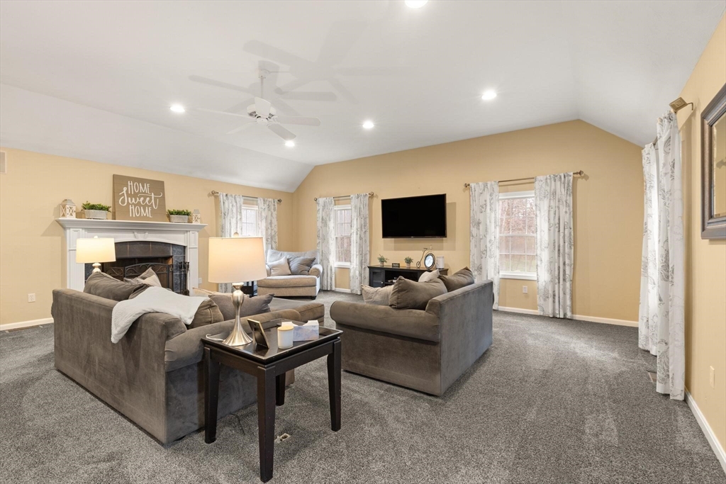 41 Chestnut Road Tyngsborough, MA 01879 - Photo 14 of 32 a living room with furniture a fireplace and a flat screen tv