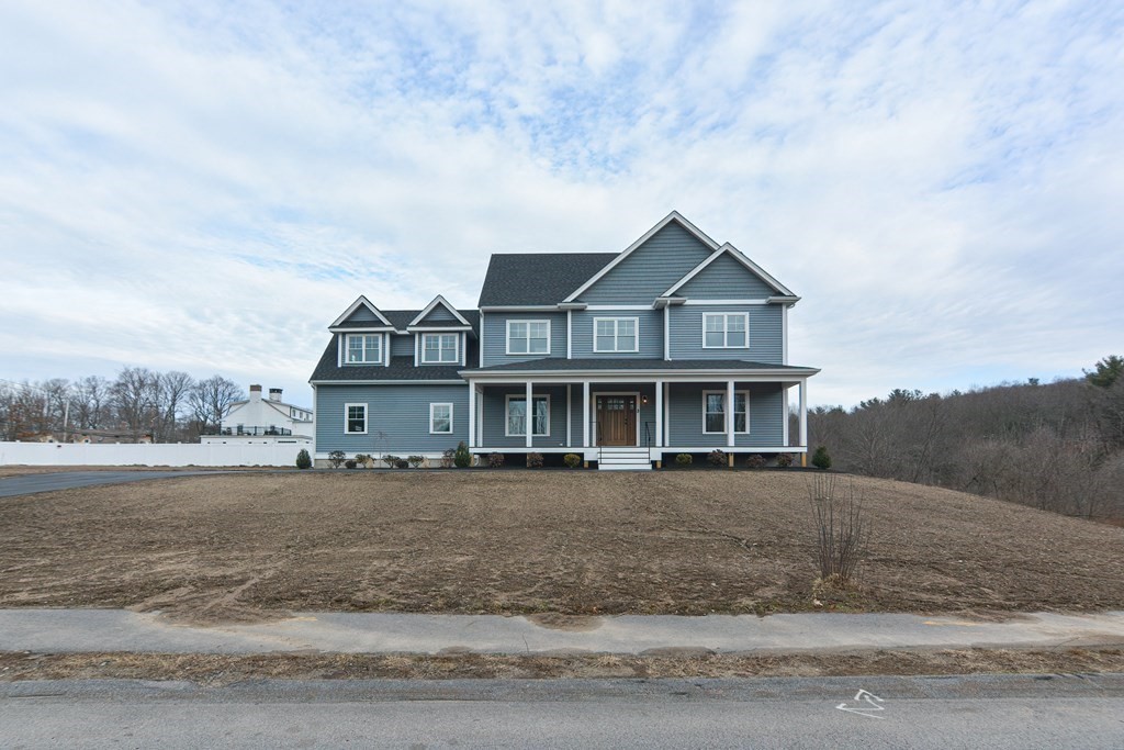 3 Badus Brook Road Wrentham, MA 02093 - Photo 2 of 38 a front view of a house with a garden