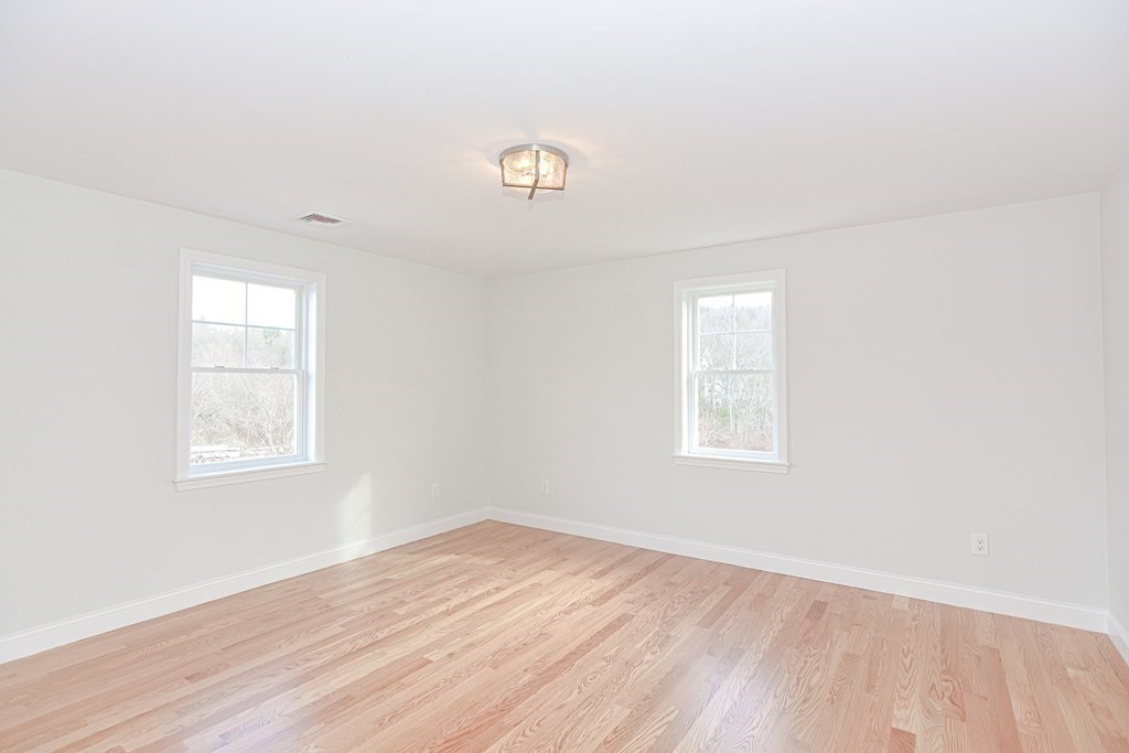 3 Badus Brook Road Wrentham, MA 02093 - Photo 27 of 38 an empty room with wooden floor and windows