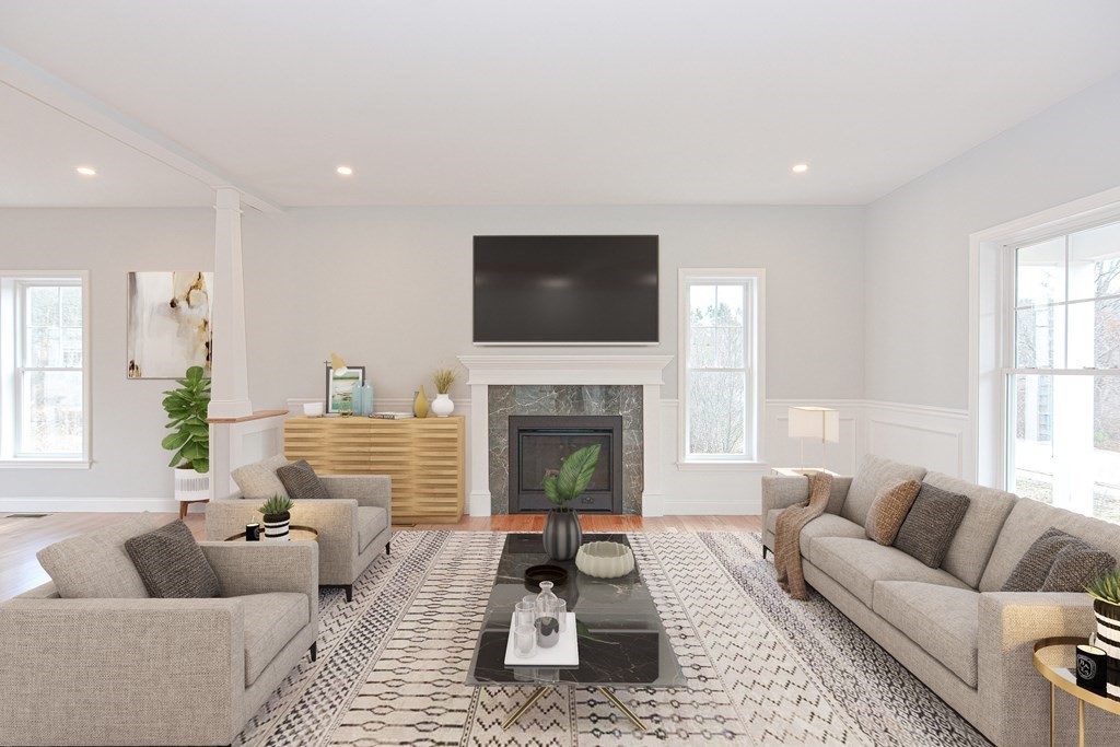 3 Badus Brook Road Wrentham, MA 02093 - Photo 9 of 38 a living room with furniture a fireplace and a flat screen tv