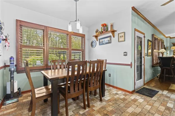 a view of a dining room with furniture window and outside view