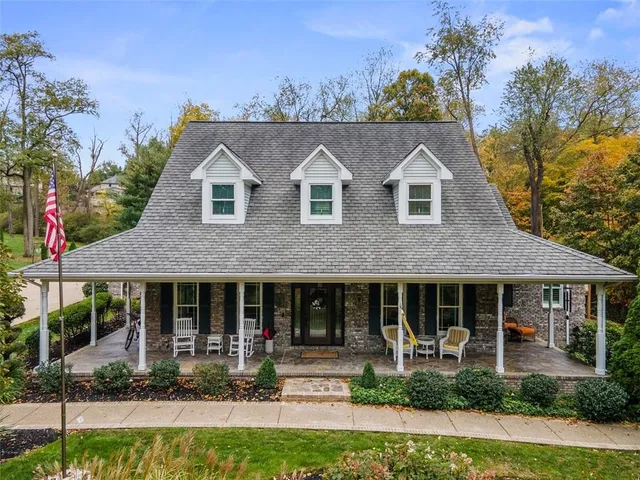 a front view of a house with a yard table and chairs