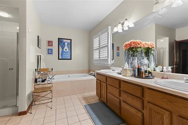 a bathroom with a tub sink and mirror