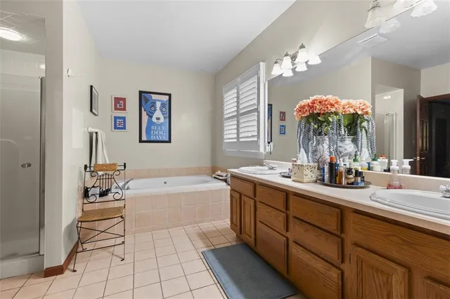 a bathroom with a tub sink and mirror