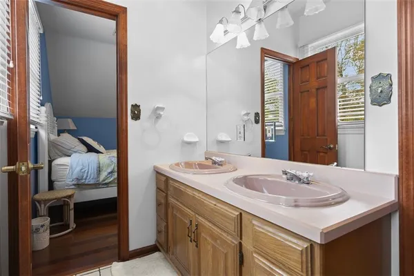 a bathroom with a sink vanity granite and a mirror