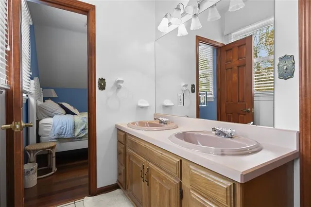 a bathroom with a sink vanity granite and a mirror