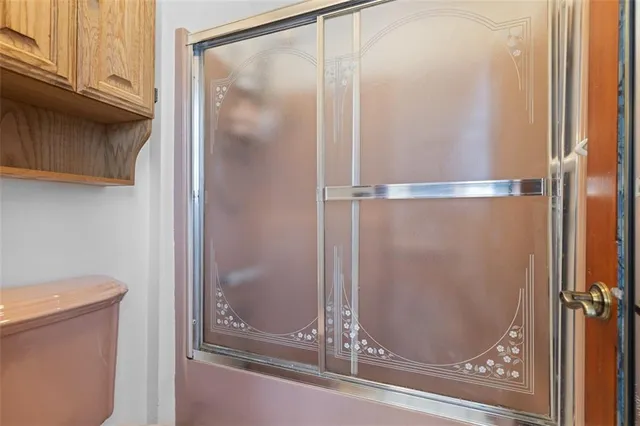 a bathroom with a glass shower door