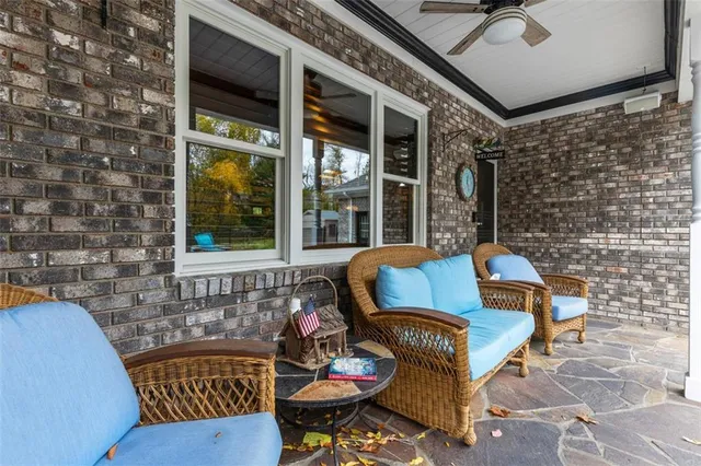 a view of a patio with couches and a table and chairs with garden view