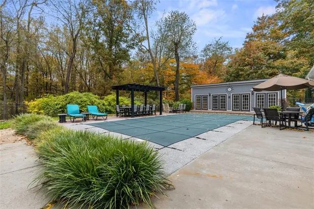 a house with lots of trees in the background