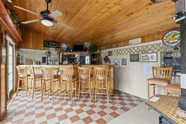a dining room with furniture and a floor to ceiling window