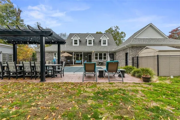 a view of a house with swimming pool and sitting area