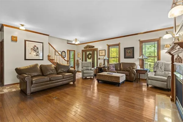 a living room with furniture and a wooden floor