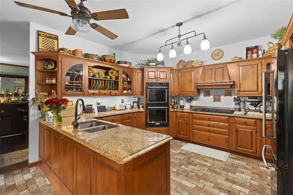 a kitchen with stainless steel appliances granite countertop a sink and cabinets