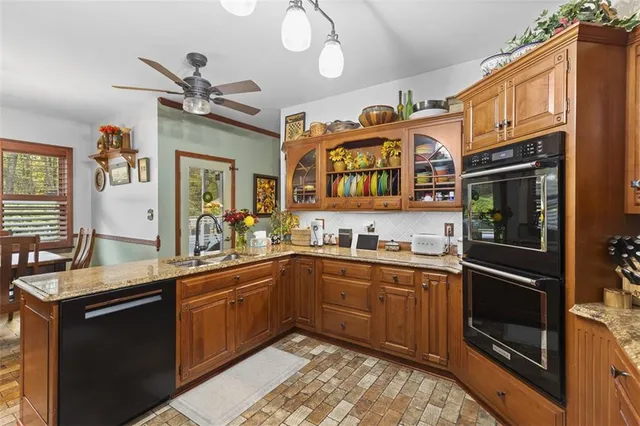 a kitchen with stainless steel appliances a sink cabinets and wooden floor