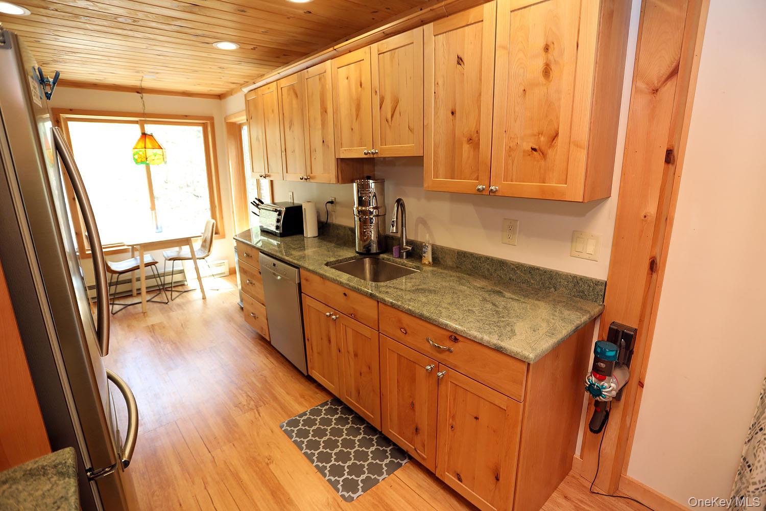 5120 Peas Eddy Road Hancock, NY 13783 - Photo 17 of 37 a kitchen with stainless steel appliances granite countertop a sink a stove and a refrigerator