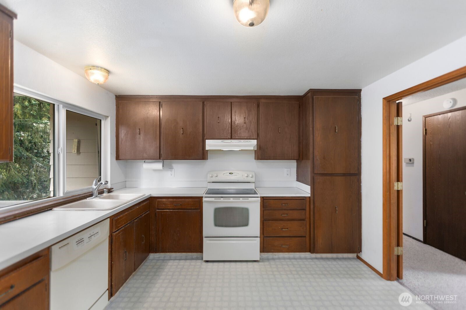 21627 9th Place West Bothell, WA 98021 - Photo 14 of 40 a kitchen with a stove sink and cabinets