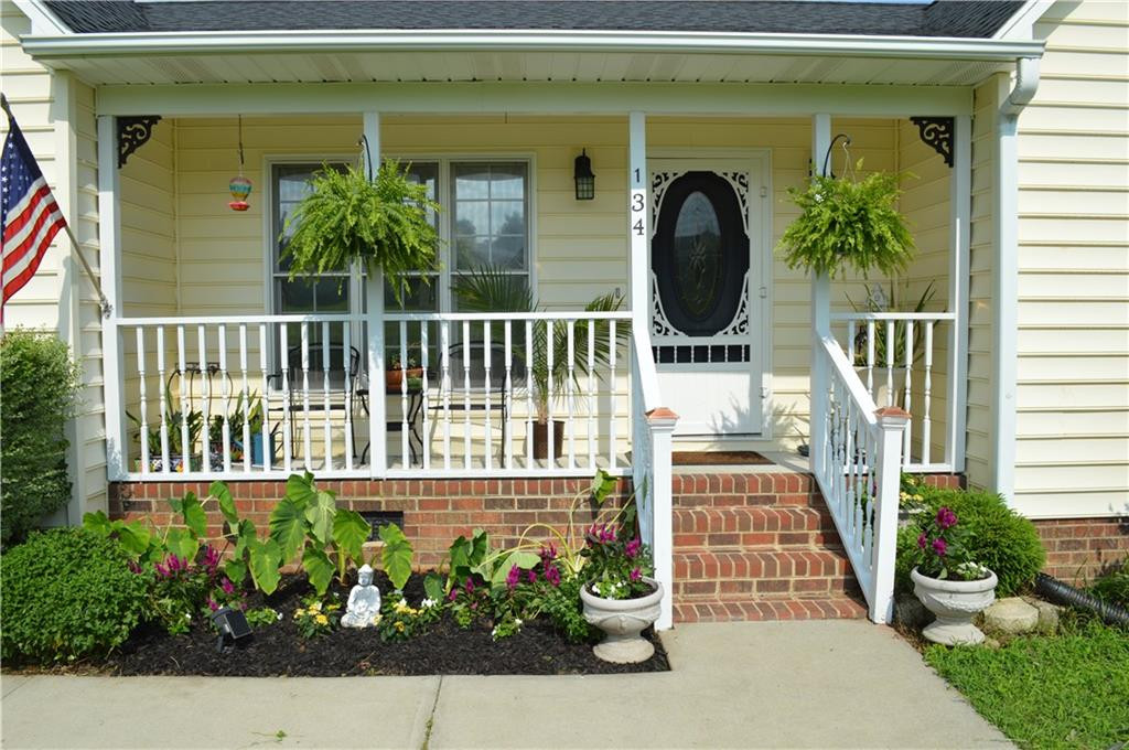 134 Collin Drive Roxboro, NC 27574 - Photo 2 of 7 a view of a house with a flower garden