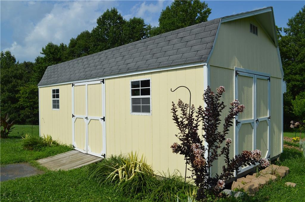 134 Collin Drive Roxboro, NC 27574 - Photo 6 of 7 a backyard of a house with plants and outdoor seating
