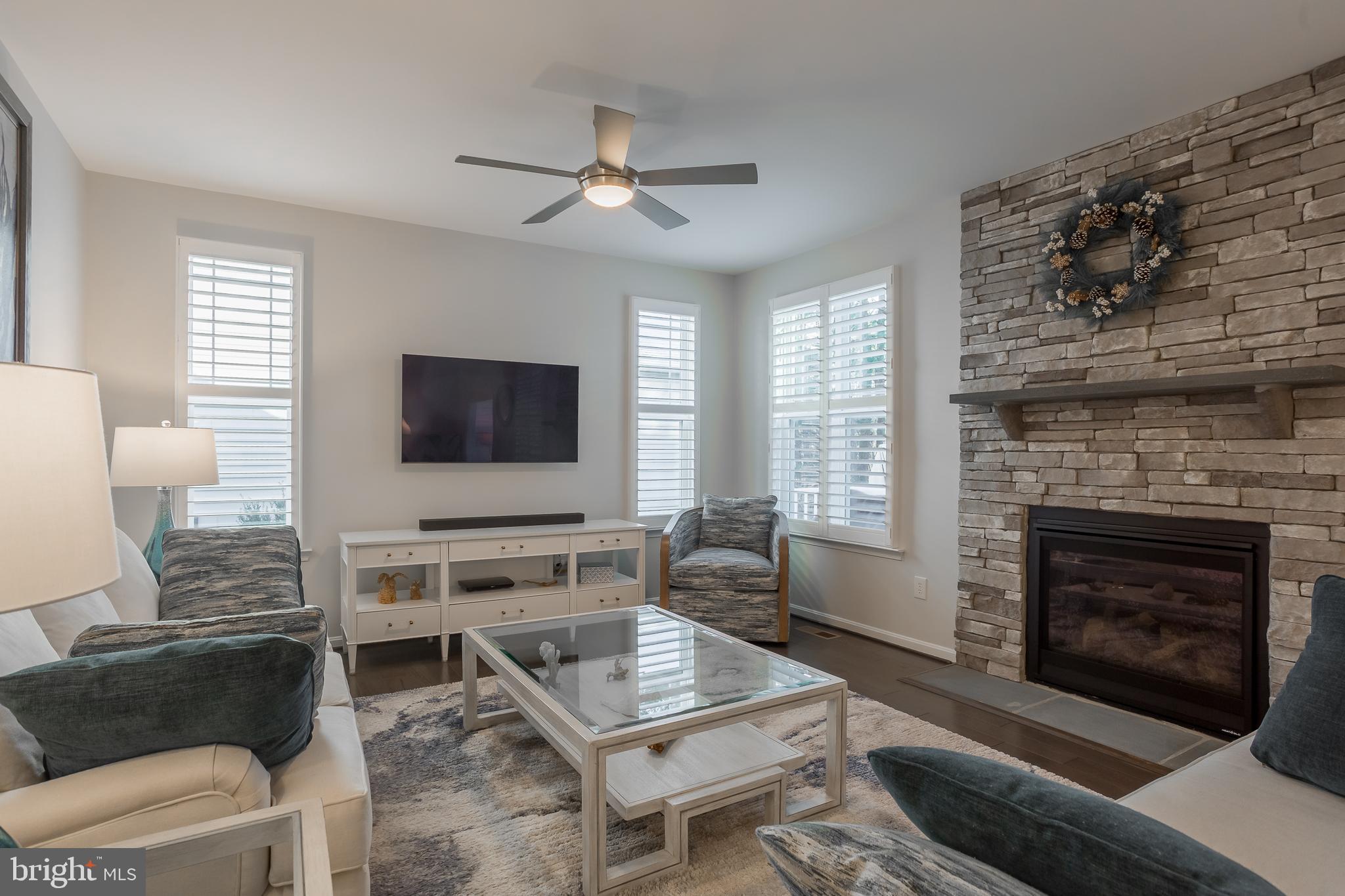34491 Spring Brook Avenue Lewes, DE 19958 - Photo 13 of 59 a living room with furniture a flat screen tv and a fireplace