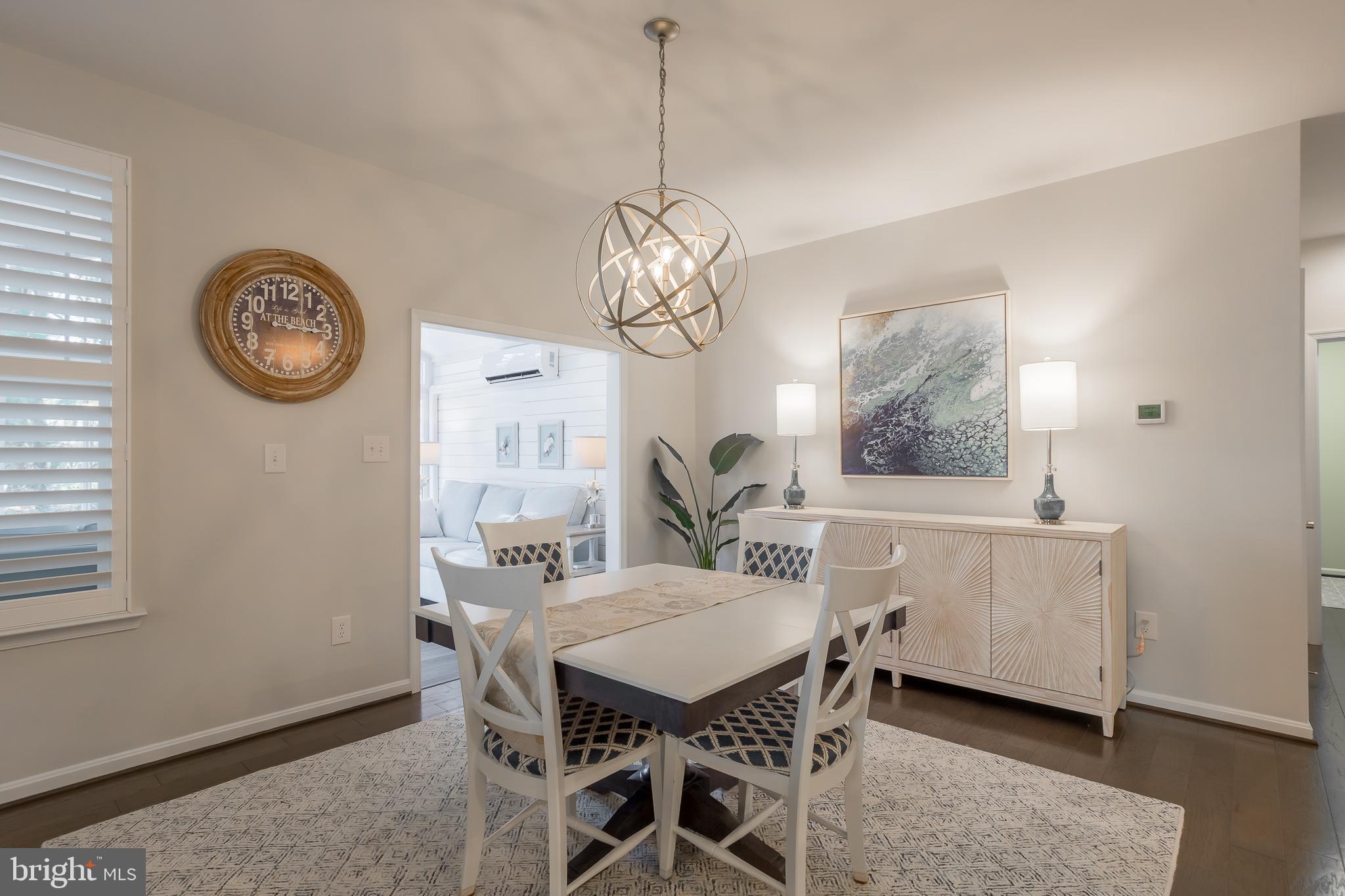 34491 Spring Brook Avenue Lewes, DE 19958 - Photo 17 of 59 a view of a dining room with furniture window and wooden floor