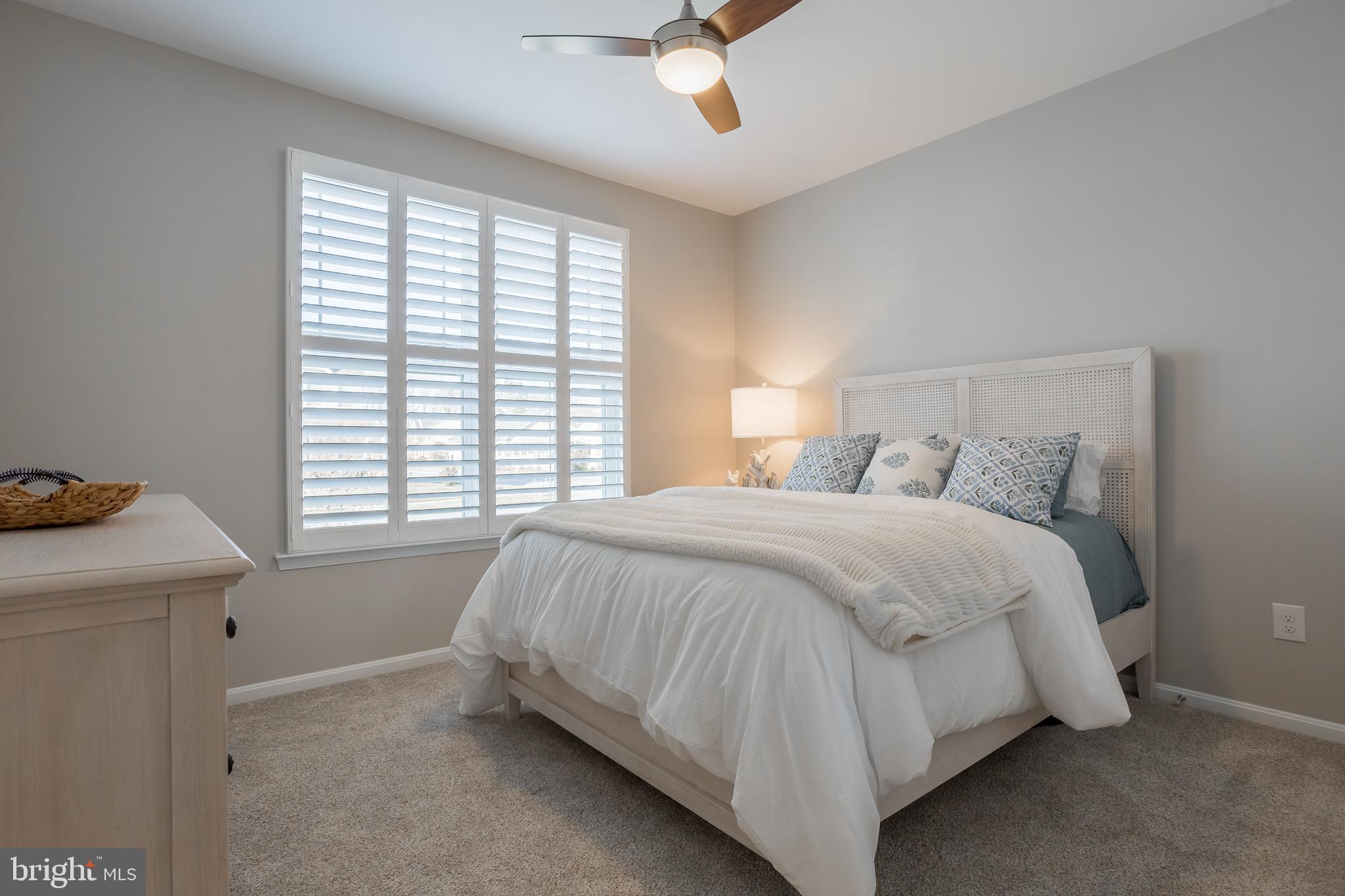 34491 Spring Brook Avenue Lewes, DE 19958 - Photo 30 of 59 a bed sitting in a bedroom next to a window