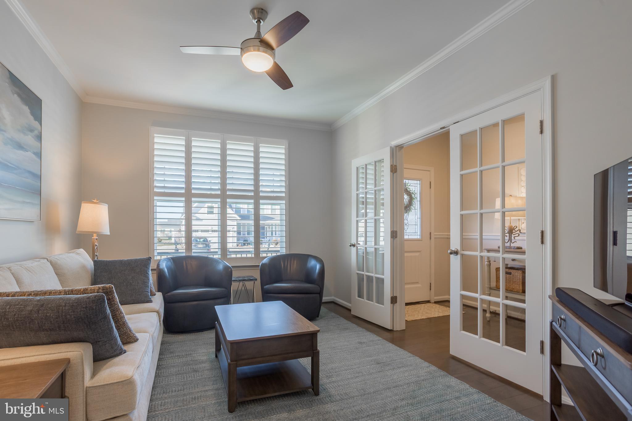 34491 Spring Brook Avenue Lewes, DE 19958 - Photo 4 of 59 a living room with furniture and a flat screen tv