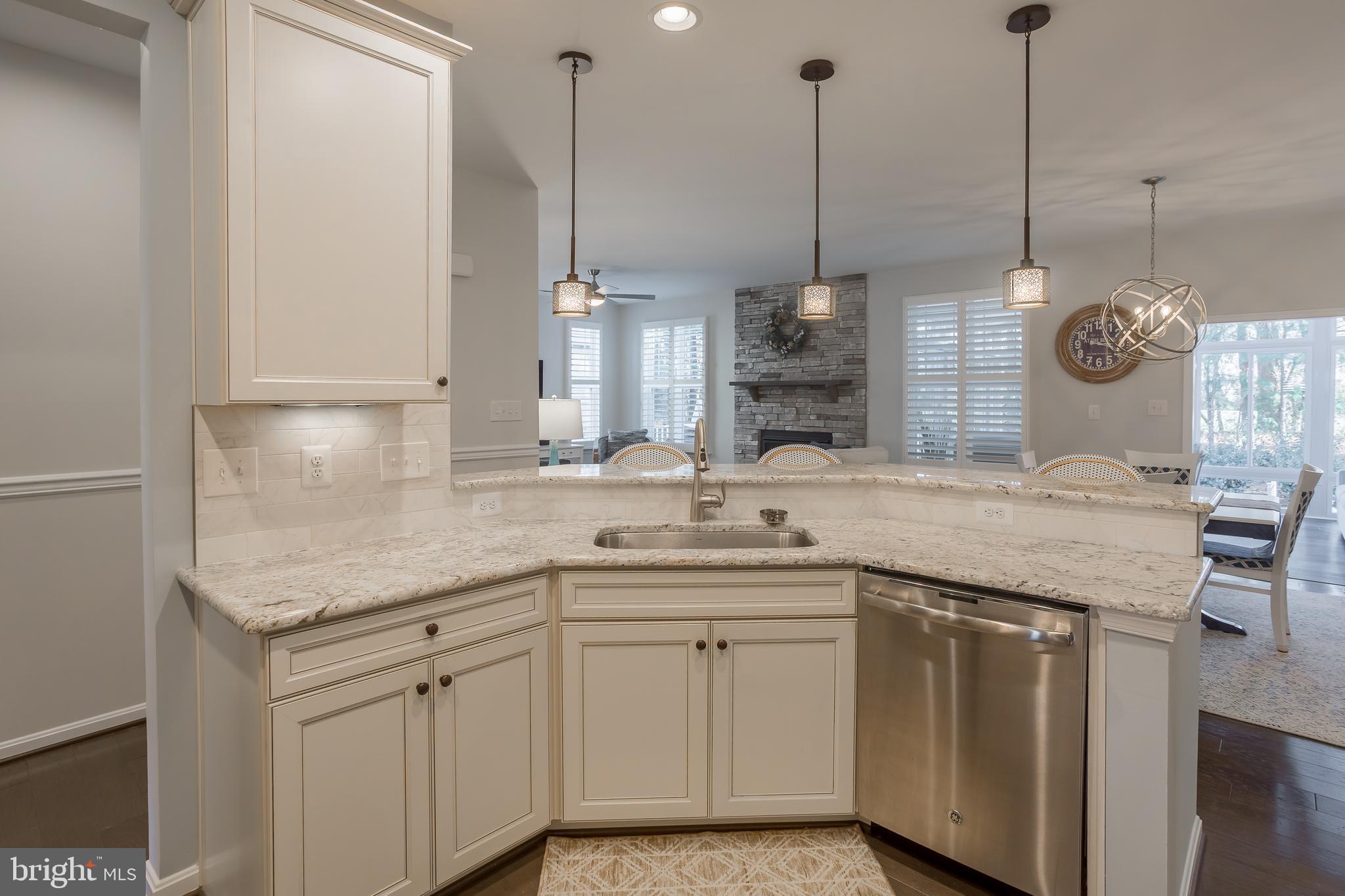 34491 Spring Brook Avenue Lewes, DE 19958 - Photo 6 of 59 a kitchen with a sink a center island and a window