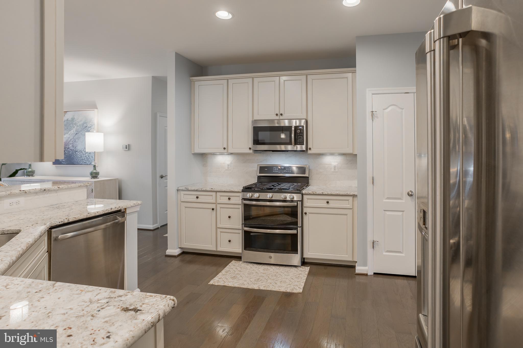 34491 Spring Brook Avenue Lewes, DE 19958 - Photo 8 of 59 a kitchen with a sink stove and refrigerator