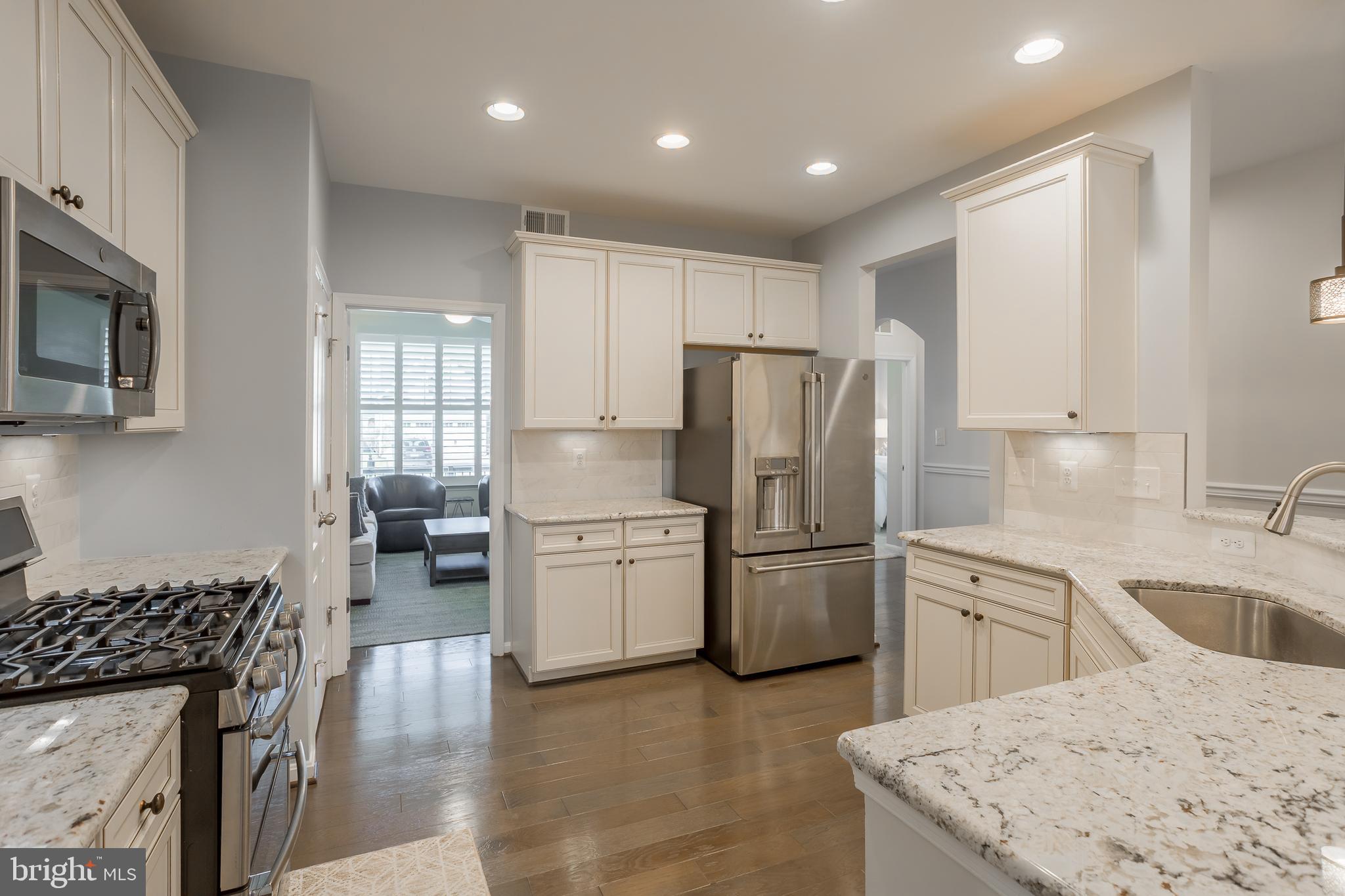 34491 Spring Brook Avenue Lewes, DE 19958 - Photo 9 of 59 a kitchen with a refrigerator a stove a sink and a microwave
