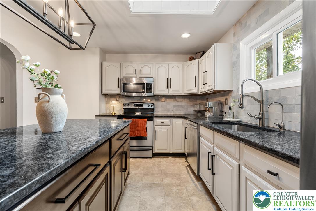 2569 Woods Edge Road Bath, PA 18014 - Photo 10 of 40 Granite countertops and crisp cabinetry anchor this updated kitchen featuring a central island.