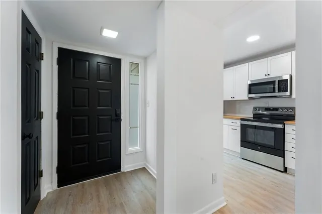 a kitchen with a refrigerator and a stove top oven