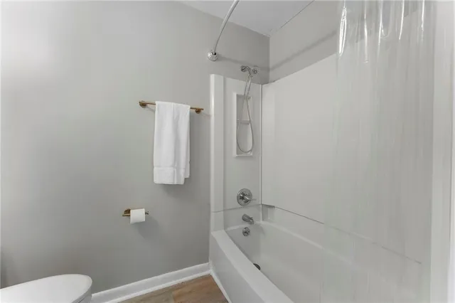 a white bath tub sitting next to a toilet