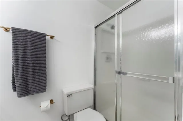 a bathroom with a shower and a toilet